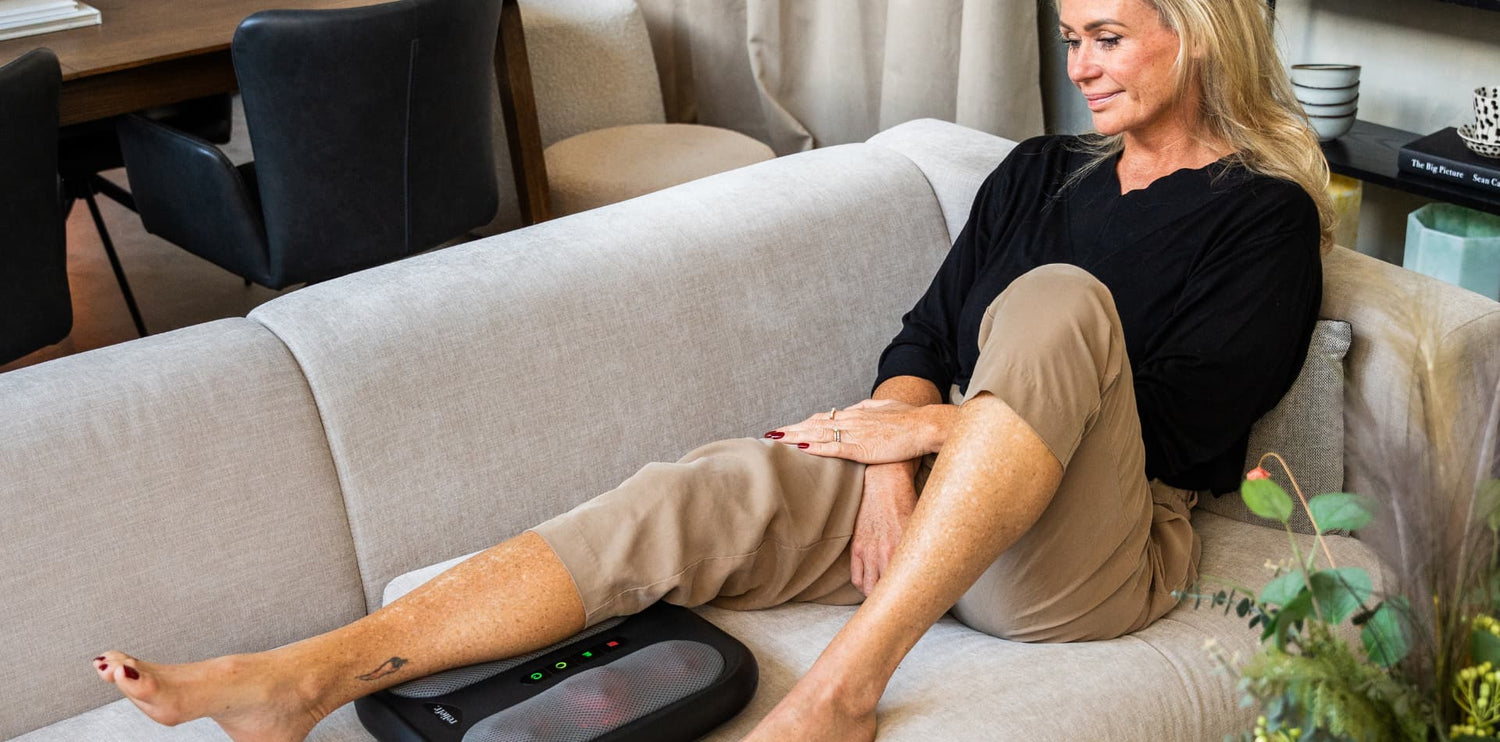 Woman relaxing with the Reliefr Fodlux Pro foot massager